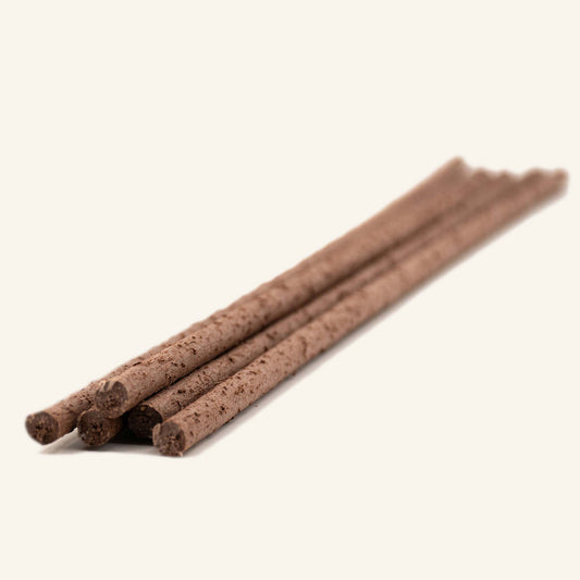 Several thin brown wooden sticks laid diagonally, biobased climbing sticks