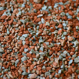 Close-up of mixed terracotta and green mineral gravel granules, orchid mineral mix